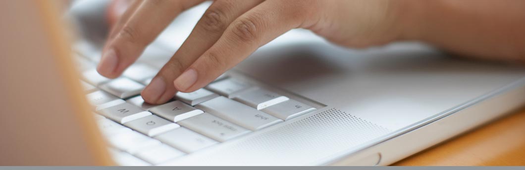 Close up of kid typing on a laptop. ©Shutterstock